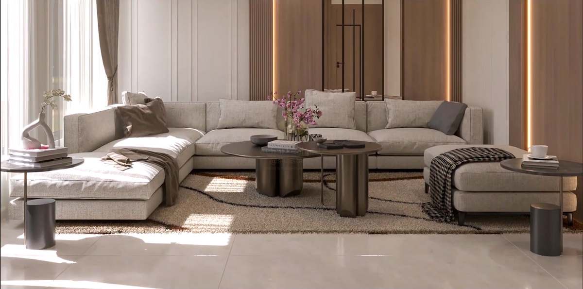 Sun-washed living room with a deep oatmeal-linen U-shaped sectional, sculpted bronze drum coffee tables on a shaggy cream rug with ink-line pattern, a houndstooth throw, pink orchids and backlit walnut slat panels beside sheer linen curtains.