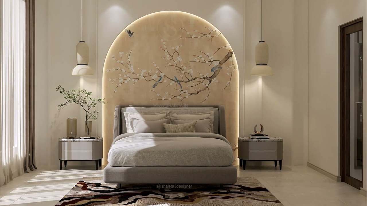 Serene ivory bedroom built around a backlit arched niche hand-painted with cherry blossom and songbirds on gold-washed plaster, a soft taupe upholstered bed, oval marble-topped nightstands, cream ribbed pendant lamps, a marbled burgundy-and-cream rug and slanting morning sun through sheers.