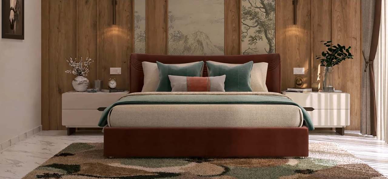 Closer view of the burgundy velvet bed dressed in oatmeal linen, sage velvet cushions and a terracotta-striped bolster, flanked by fluted ivory nightstands with brass clock and blossom vase, warm wall-washer sconces on oak planks behind.