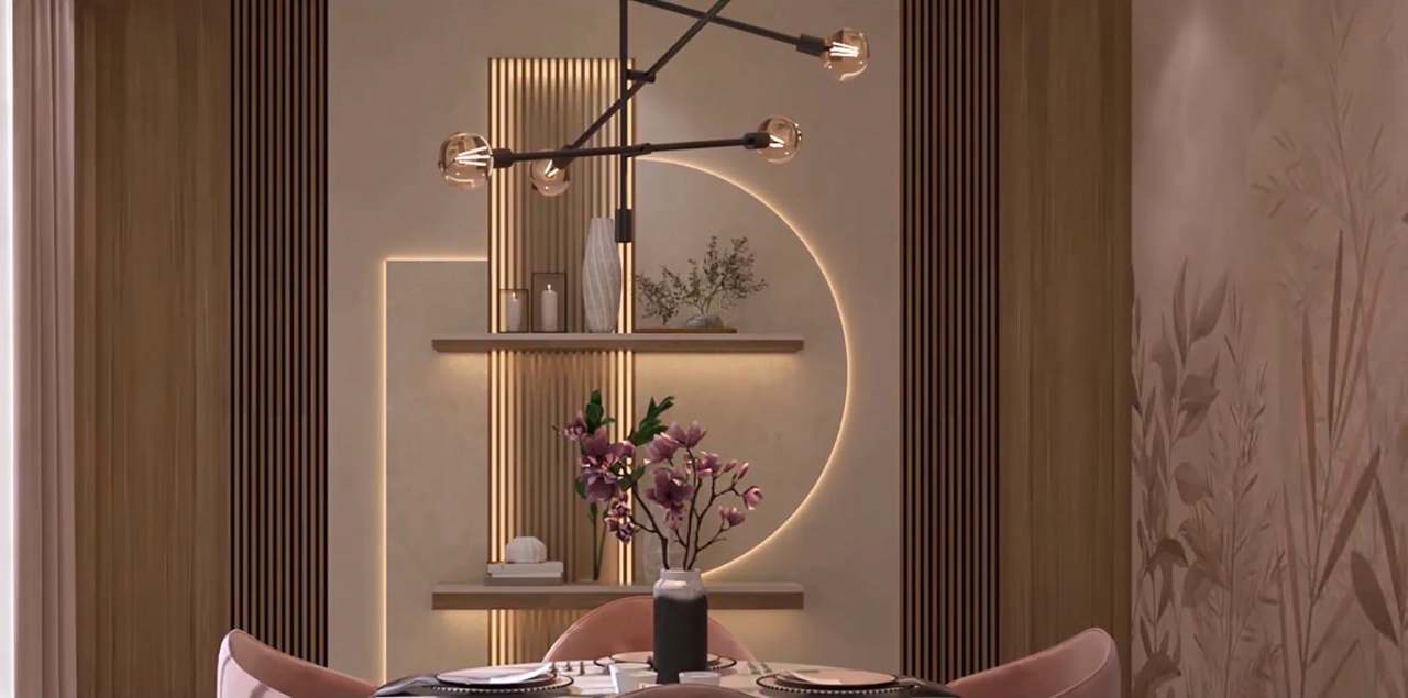 Feature-wall detail: a warm LED half-moon outline and lit oak-slat strip framing floating shelves styled with candles, a fluted vase, bonsai and magenta magnolia stems, under a matte-black branching chandelier with amber filament globes.