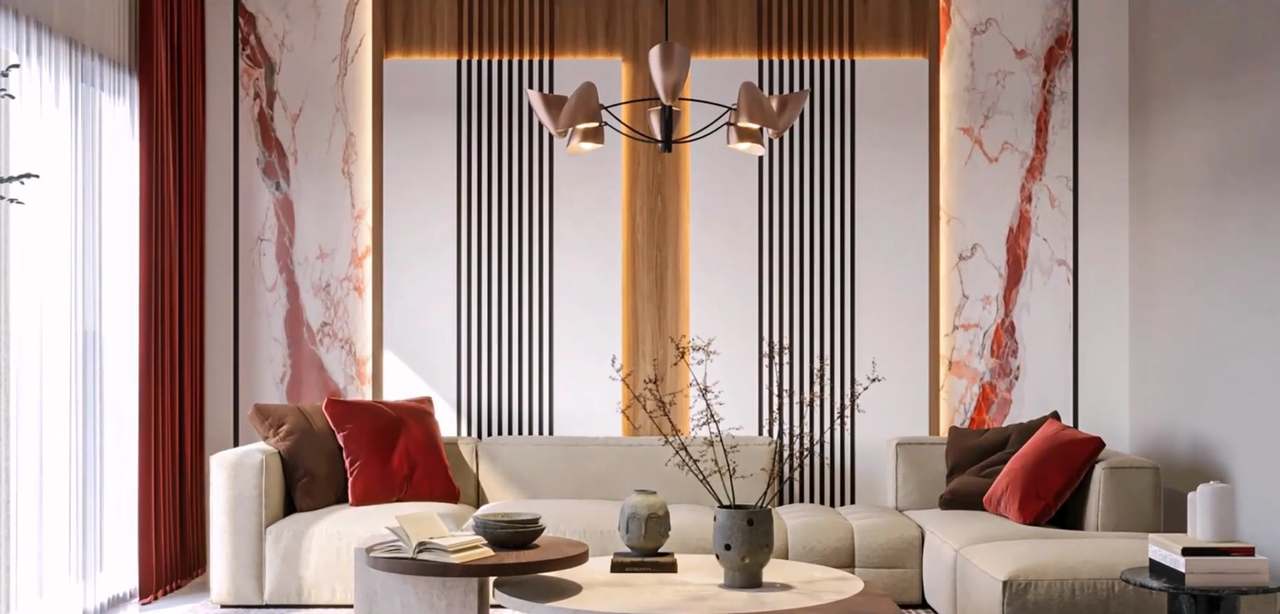 Closer view of the red-veined marble and black-slat feature wall with a glowing oak centre strip, a blush cone chandelier, cherry-blossom branches in a pitted stone vase, a ceramic face vase and an open book on a white-and-walnut coffee table before the oatmeal sectional.
